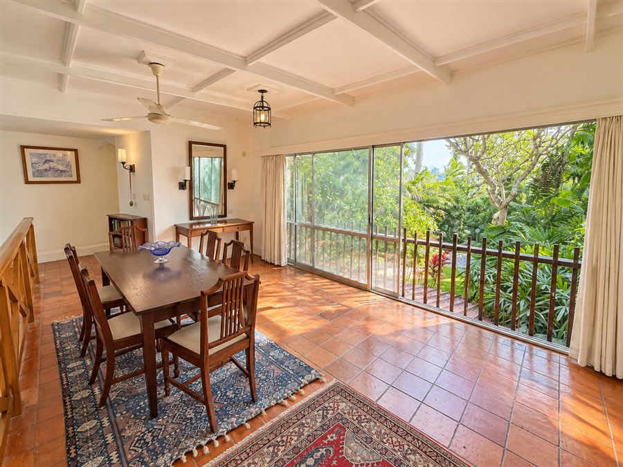 Dining room with a wall of sliding windows onto the garden